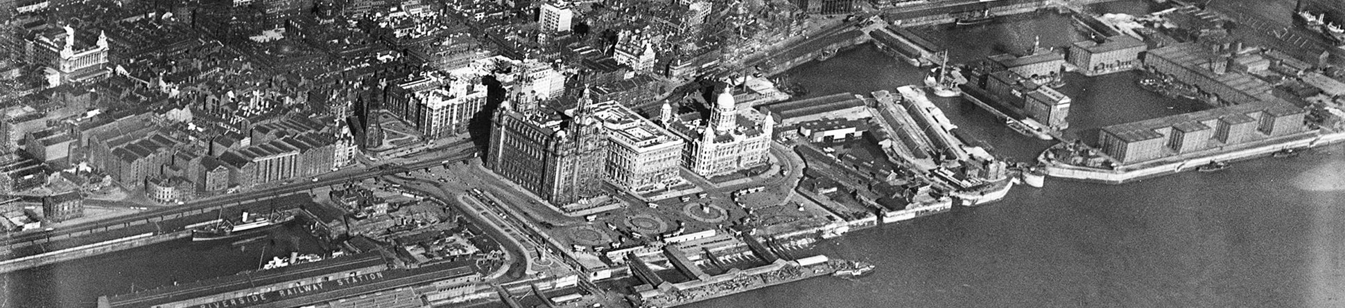 Aerial view of the waterfront with boats heading towards the port