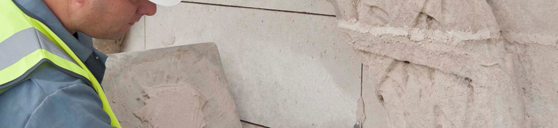 Image of a workman restoring a war memorial.