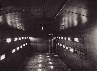 Interior of First World War armoured train carriage. The troops travelling in these carriages would have had to stand or lie down. The ‘loopholes’ along each side were for firing rifles. © Swindon Railway Museum