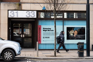 A person walks past a window installation